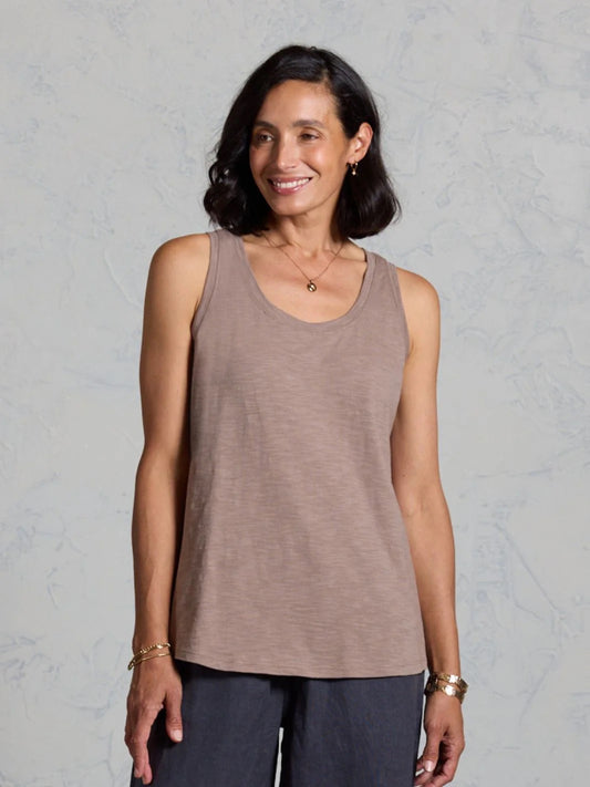 Woman wearing a brown tank top against a gray background